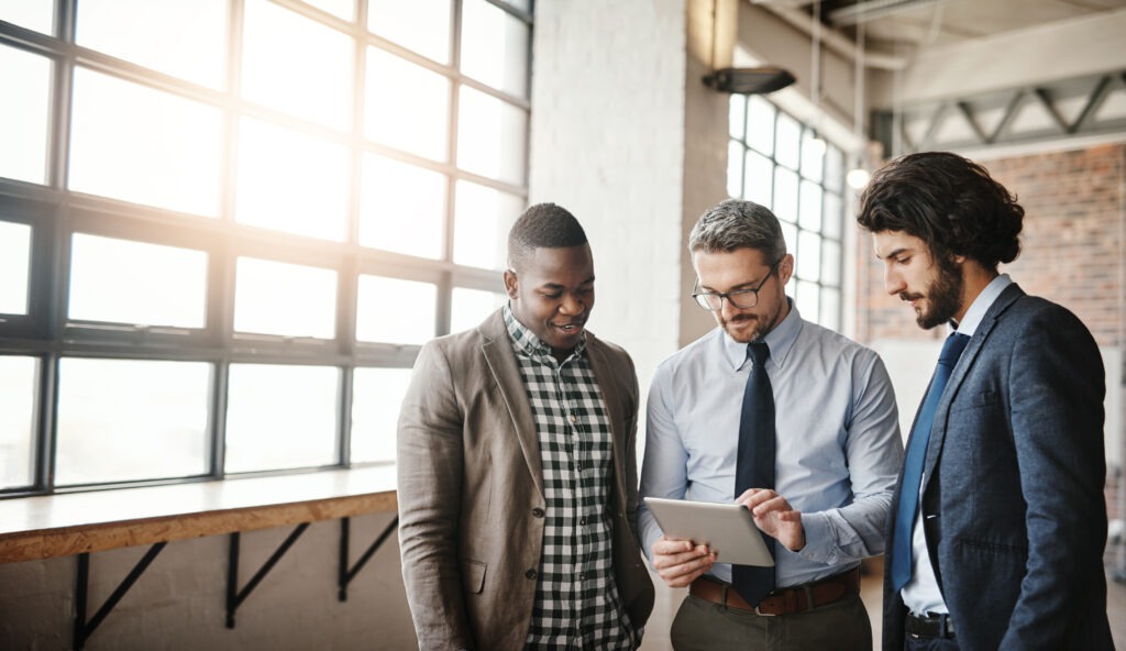 business men teamwork reading tablet collaboration research results startup investment professional manager people group planning digital tech sales profit office scaled